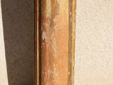 a vase that is sitting on the ground near a wall
