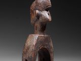 a wooden statue of a man with a hat on his head
