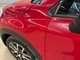 a close up of a red car with a parking meter