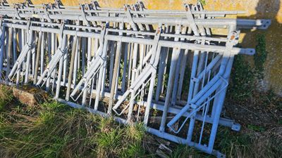 a lot of metal bars that are sitting in the grass