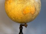 an image of a yellow and black globe on a black stand