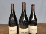 three bottles of wine sitting on top of a table next to each other