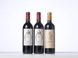 three bottles of wine are lined up on a table
