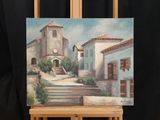 a painting of a building on a easel with a clock