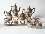 silver plated tea and coffee set on a tray with silverware