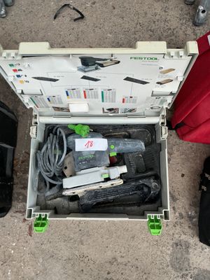 an open box with tools in it sitting on the ground