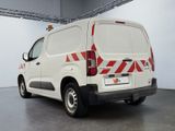 a white van with red and white stripes parked in a garage