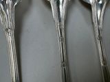 four spoons that are sitting next to each other