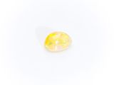 a yellow oplite stone on a white background