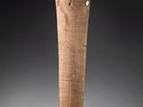 an old wooden stick with a wooden handle sitting on top of a table