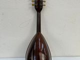 a mandolin hanging on a wall next to a white wall