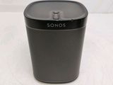 a close up of a black speaker sitting on top of a table