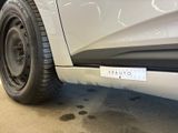 a close up of a white car with a sticker on it
