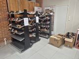a room with a lot of shoes and boxes on the floor
