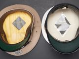 two hats that are sitting side by side on a table