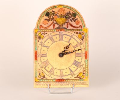 a clock that is sitting on a stand on a table