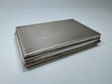 an antique silver cigarette case on a white background