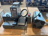 lot of two industrial electric heaters sitting on top of a box in a warehouse