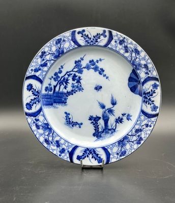 an image of a blue and white plate with birds and flowers on it