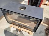 a metal box with a hole in it sitting on a pallet