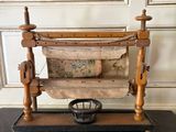 an old fashioned sewing machine sitting on top of a wooden table