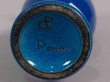 a close up of a blue vase with writing on it