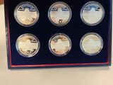 six coin set in a blue box on a table