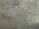 an image of a silver plate with a stamp on it