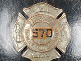 a firefighter ' s badge on the back of a black purse