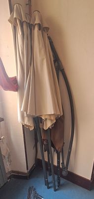 a coat rack that has two umbrellas hanging on it