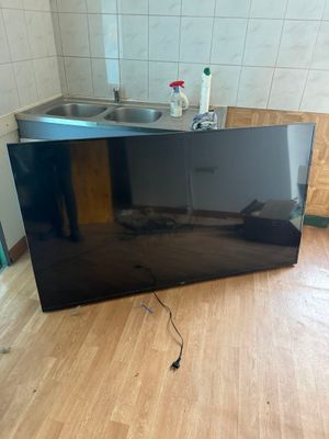 a tv that is sitting on the floor in the kitchen