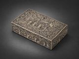 a silver box with a design on the lid