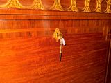 a wooden cabinet with a key on it in a room