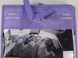 the purple bag has a picture of a bed in it