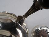 a silver tea pot and a silver teapot on a table