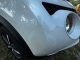 a close up of the front bumper of a white car