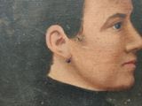 portrait of a man with ear piercings in a black sweater