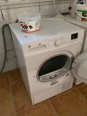 a washer and a toilet in a small room
