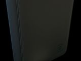 a close up of a black binder with a piece of paper next to it