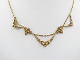 a close up of a gold necklace on a mannequin mannequin