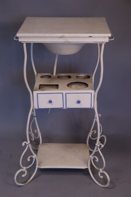 a small white table with two drawers and a sink