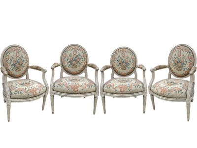 a set of three chairs with floral upholstered cushions