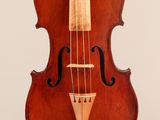 an old violin sitting on a white surface with a white background