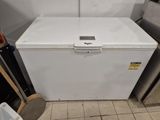 a white refrigerator sitting in a kitchen next to a trash can