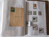 an open book with stamps on it on a table