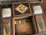 a wooden box that has a picture of a flower inside of it