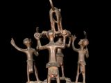 bronze statue of a group of people with a man on a boat