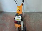 a small lawn mower sitting on the floor in a room