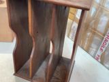 a small wooden table with a book shelf on top of it