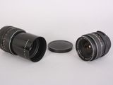 two lenses sitting next to each other on a white surface